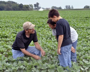 father-teaching-sons-farming