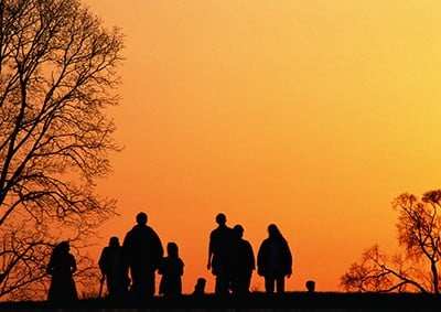 family-walking-at-sunset-together